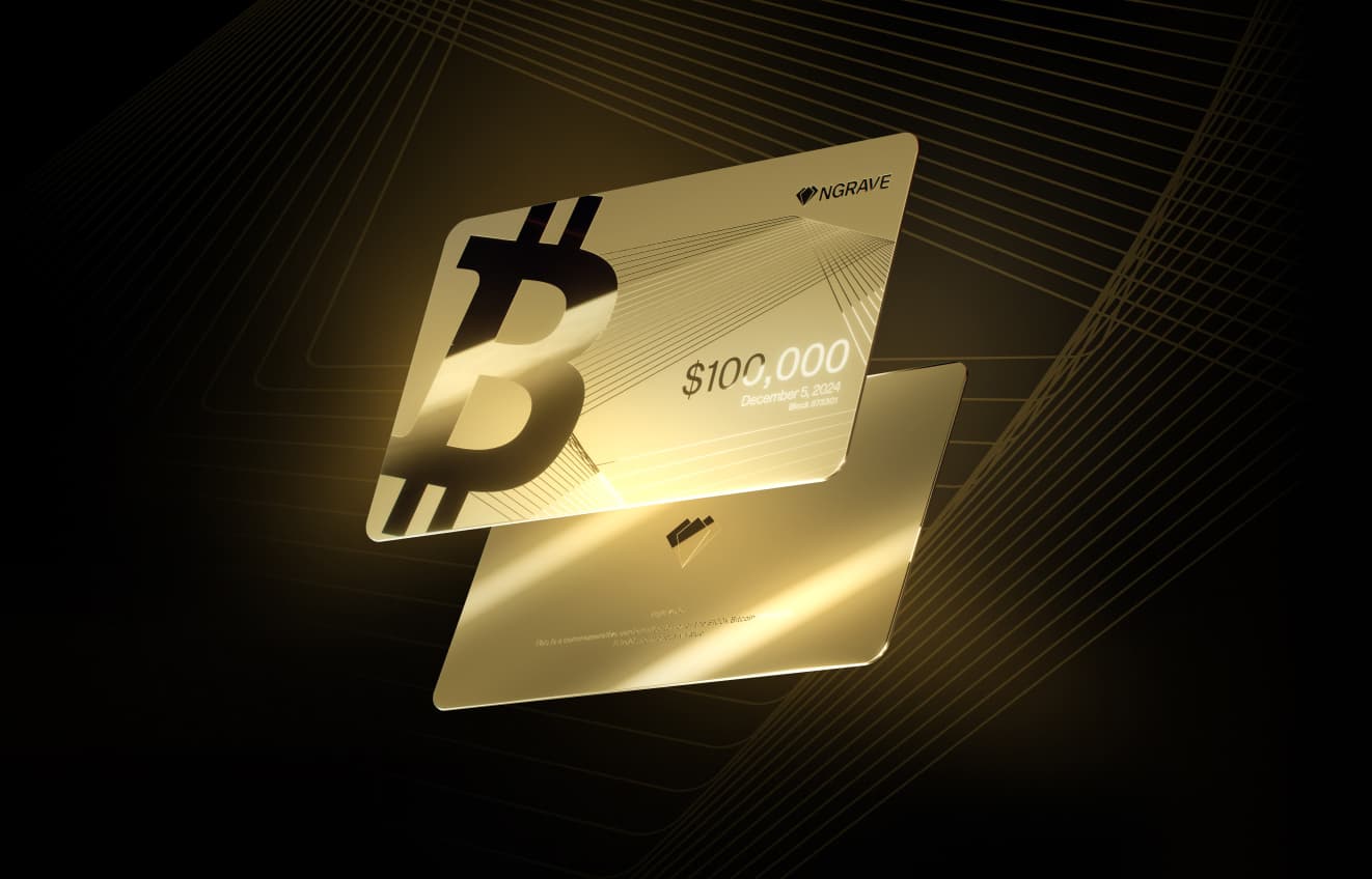 Gold NGRAVE cards marking Bitcoin's $100,000 milestone, shown front and back