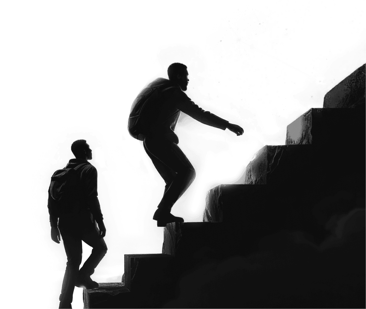 Silhouette of one man helping another climb a set of stone steps
