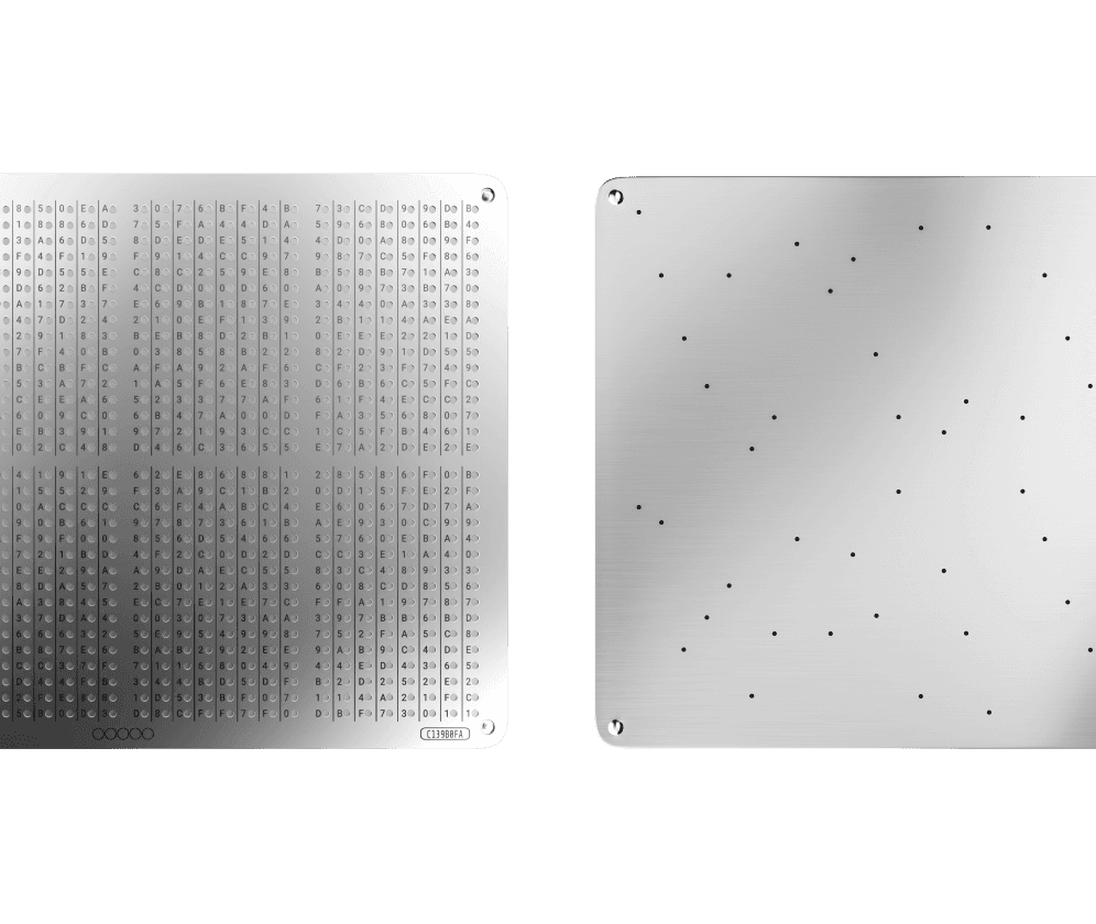 Two GRAPHENE steel plates: a character grid plate and a plate with scattered punched holes encoding the key
