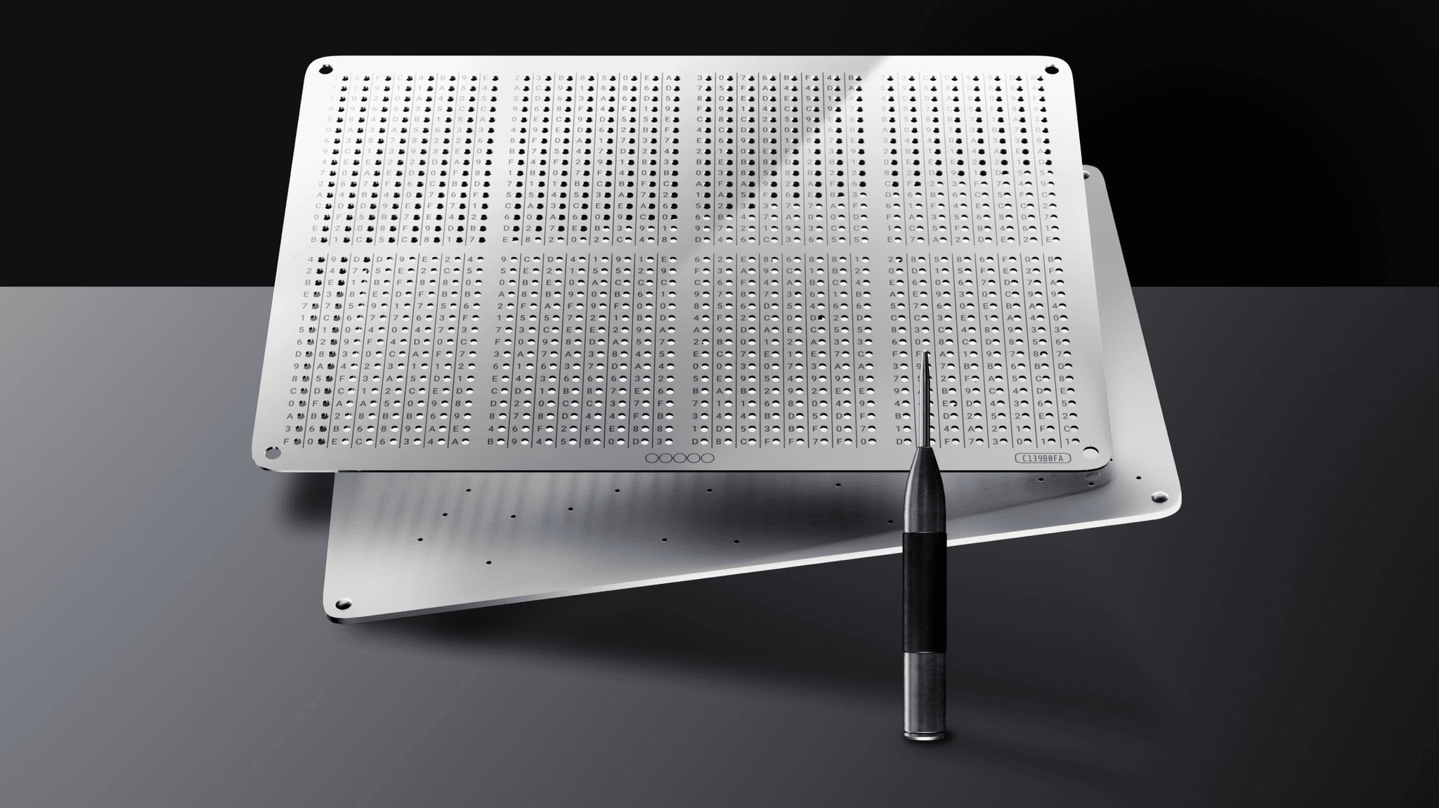 NGRAVE GRAPHENE steel backup plates resting on a surface with the engraving punch tool