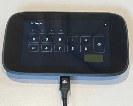 NGRAVE ZERO displaying a Log in screen and with a connected USB cable.
