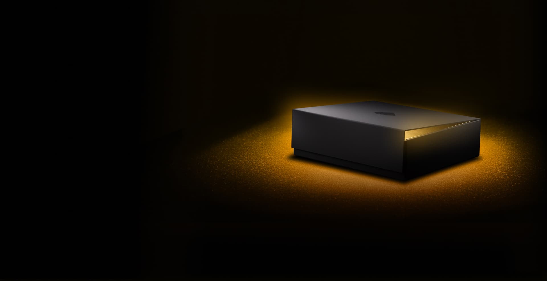 Closed black NGRAVE box glowing with golden light in the dark