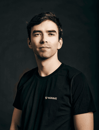 Portrait of a dark-haired man in a black NGRAVE T-shirt